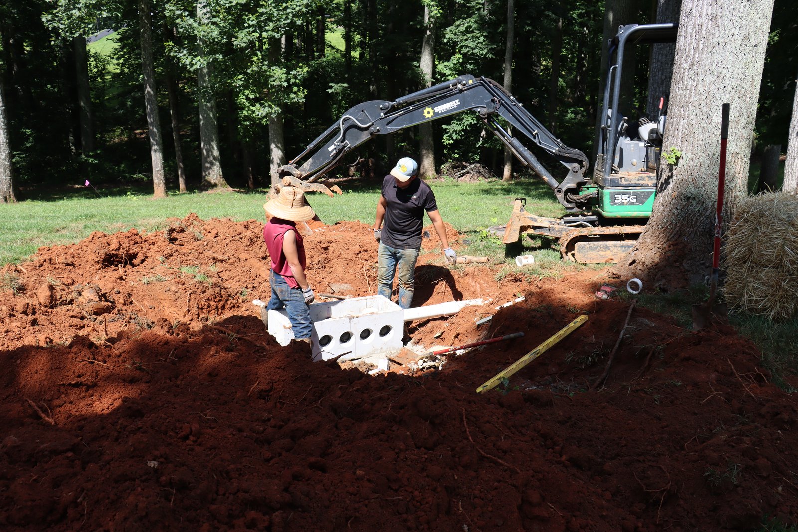 Excavating septic system installation in backyard