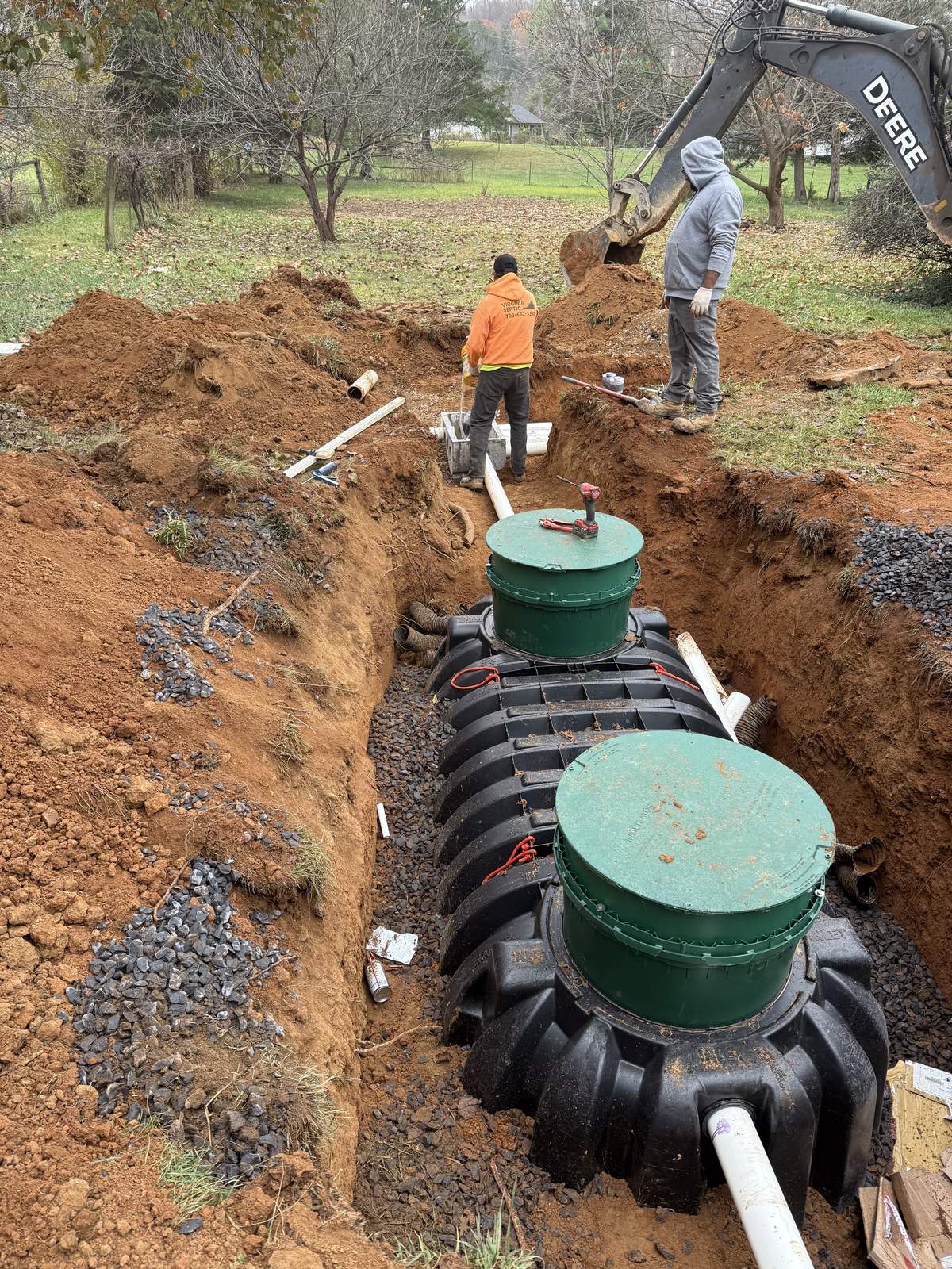 Septic installation in progress at residential site with excavation
