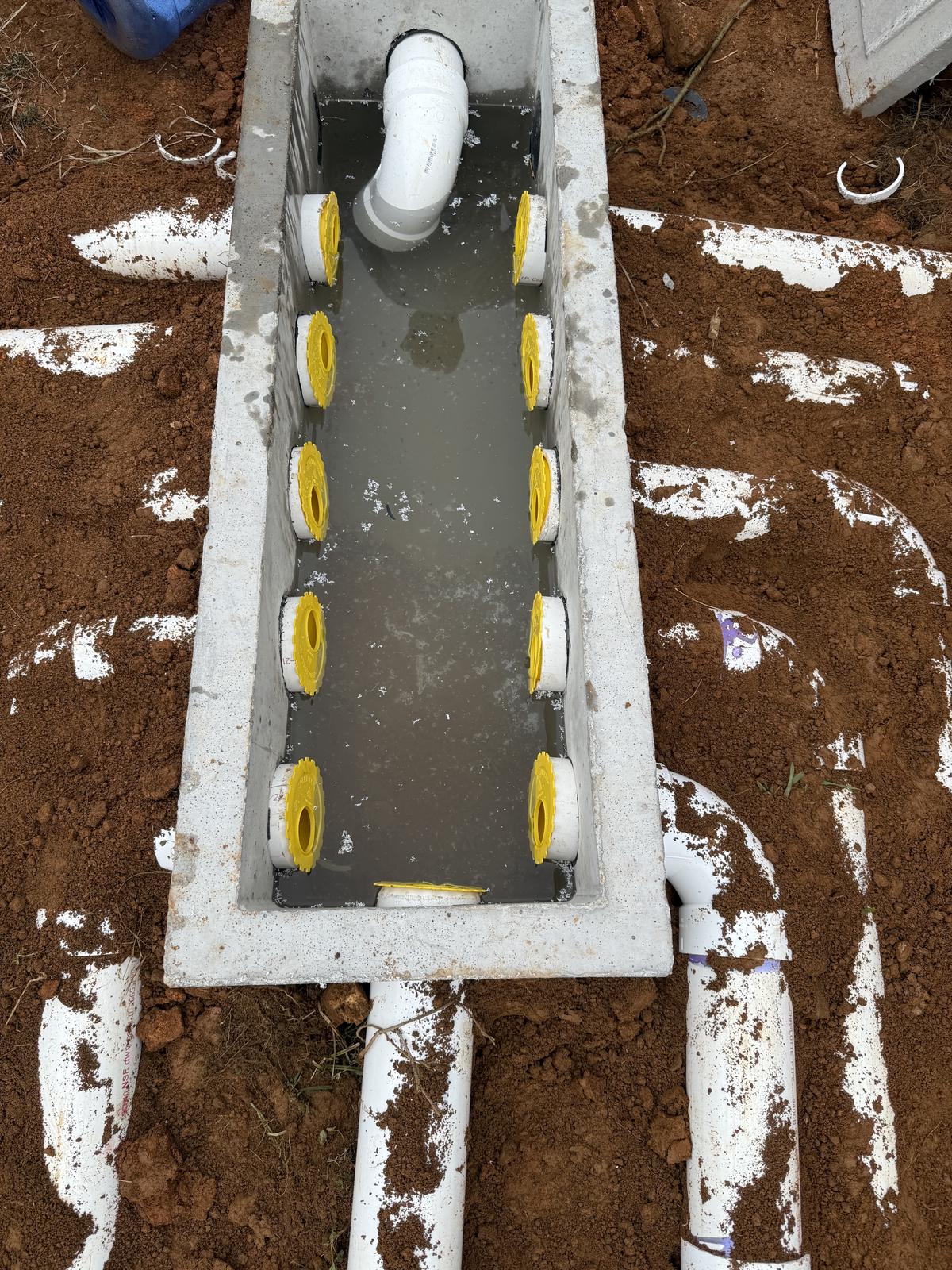 Septic installation pipes and gravel in ground worksite