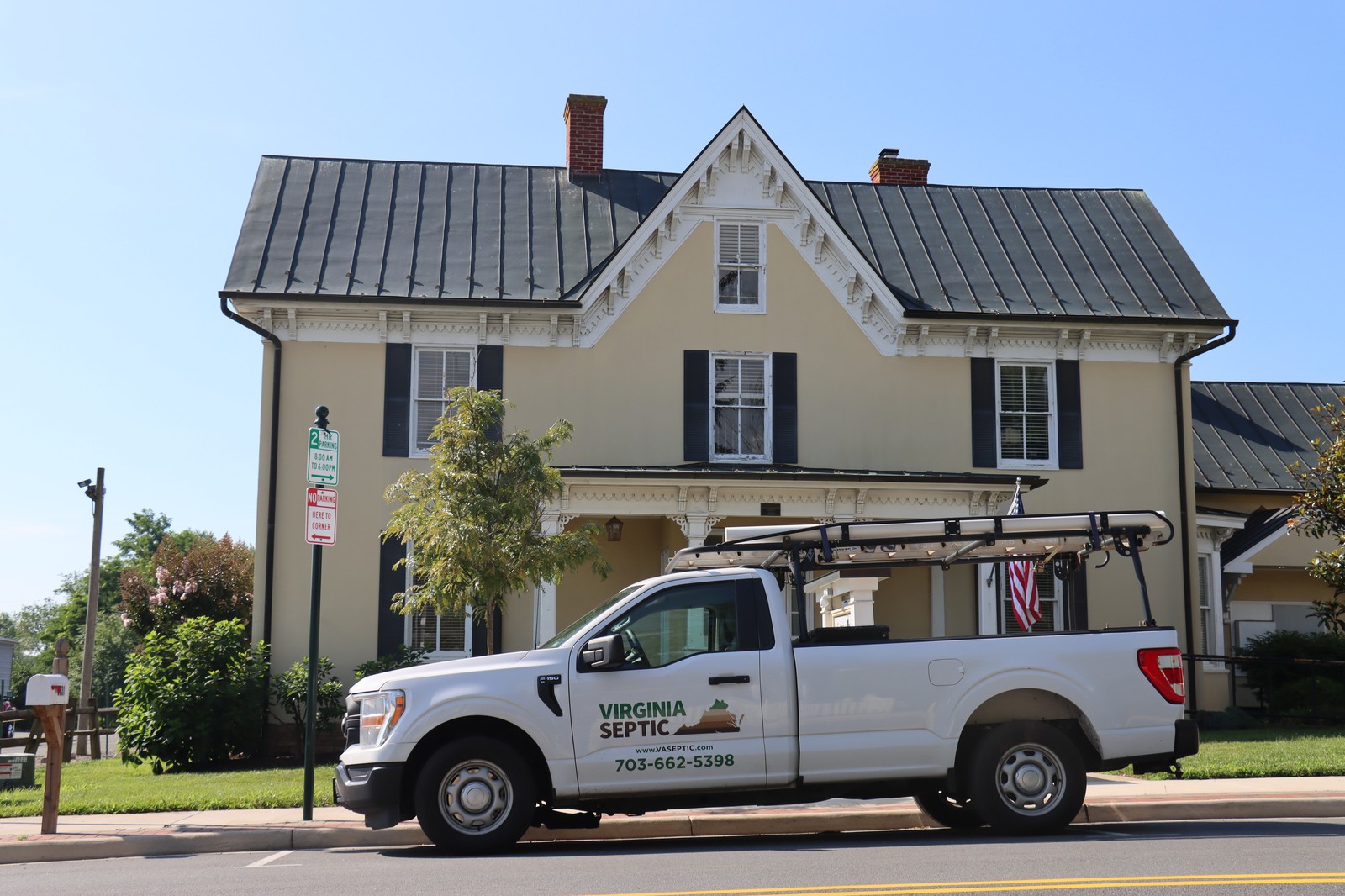 White truck parked in front of historical house Virginia Septic