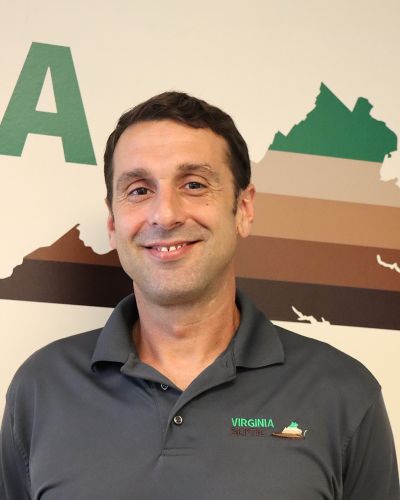 Josh Virginia Septic worker smiling in front of map background
