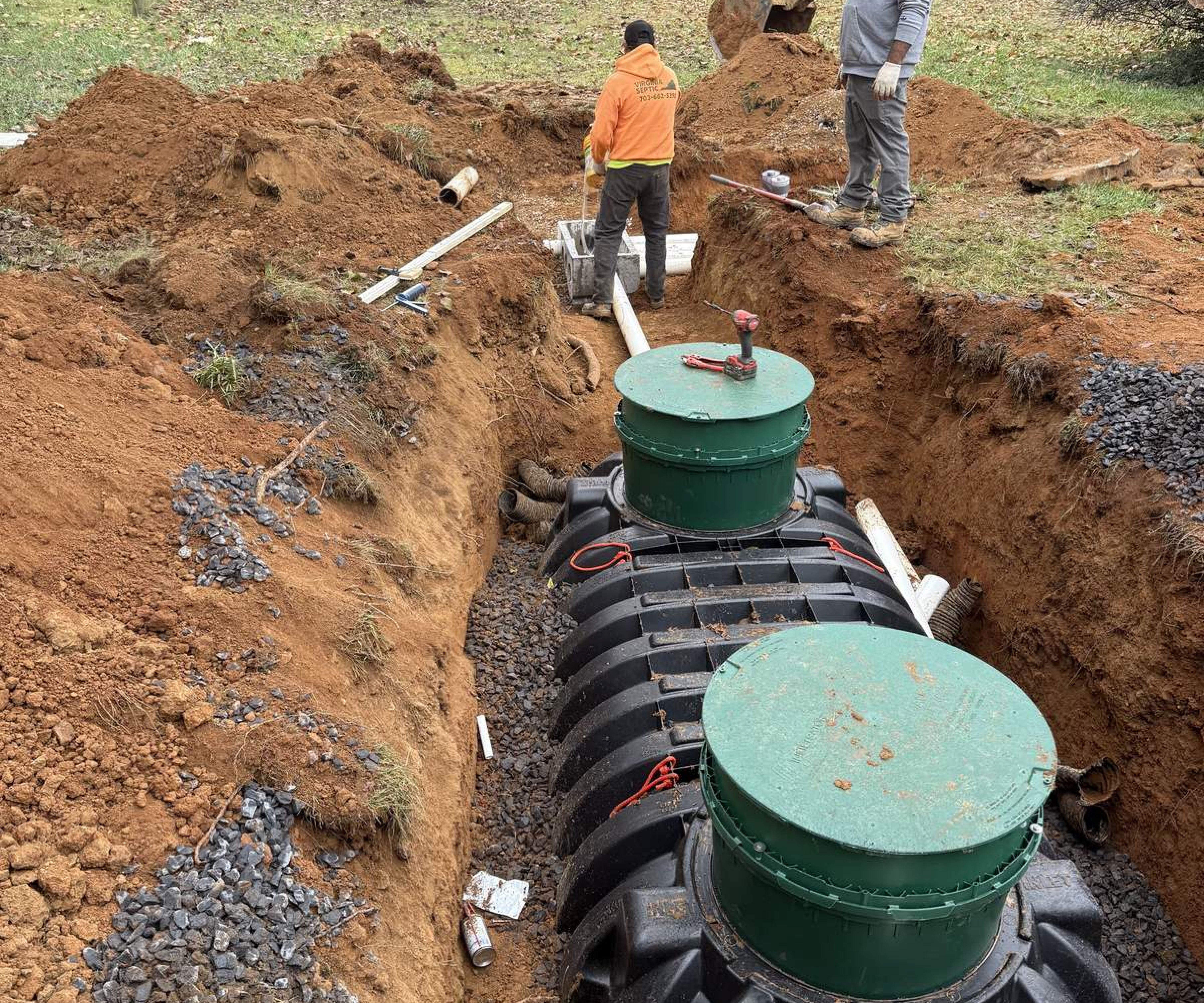Septic installation in progress at residential site with excavation