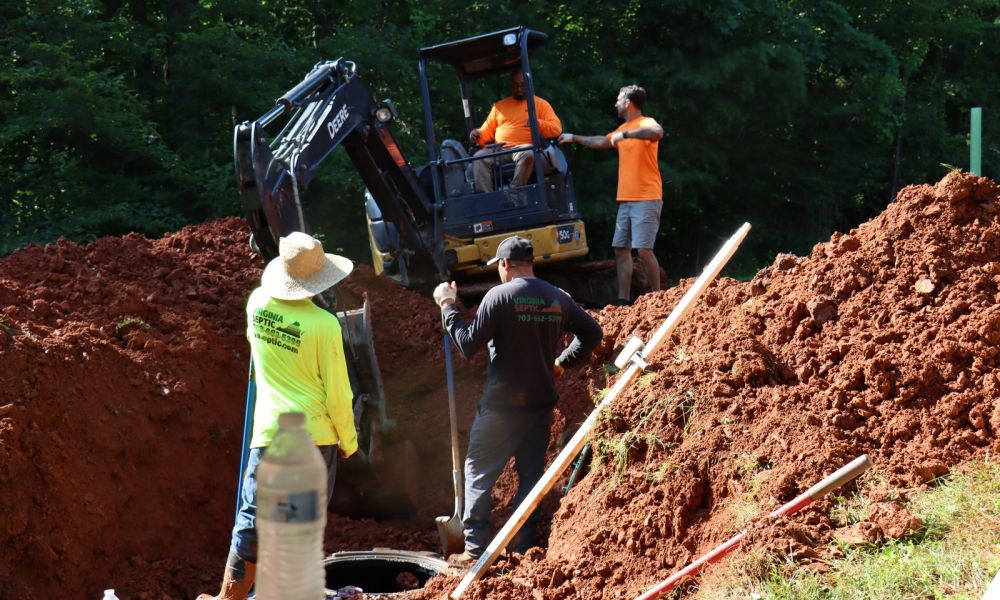 Construction of septic system with excavation and workers