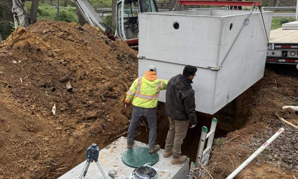 Septic tank installation site workers digging and progress
