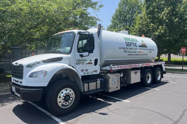 Virginia Septic truck in parking lot with trees nearby
