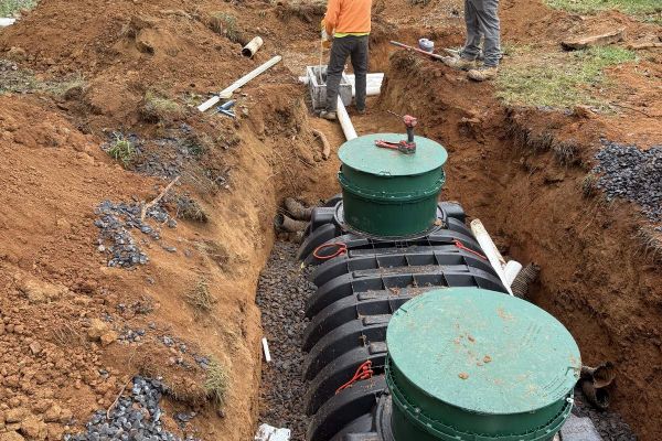 Septic installation in progress at residential site with excavation